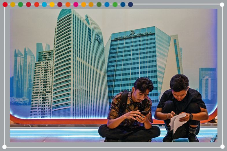 People fill out applications during a job fair organised by Airlangga University in Surabaya on 29 April 2025 People fill out applications during a job fair organised by Airlangga University in Surabaya on 29 April 2025