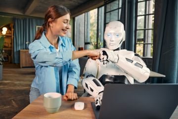 Woman and robot fist pumping