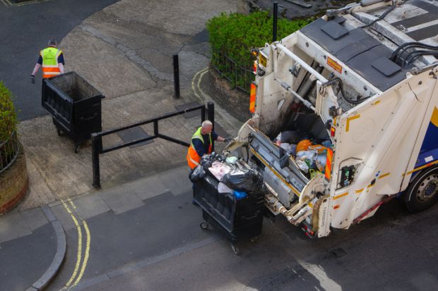 A rear loader truck collecting rubbish in central London