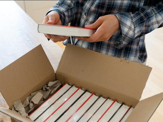 An author looks at a delivery of books