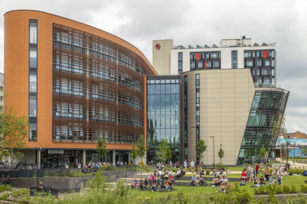 people relaxing on the grounds of De Montfort University