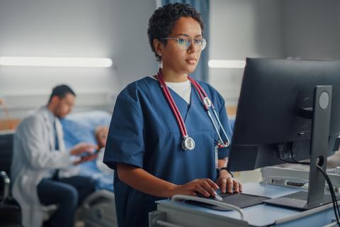 Nurse entering information into computer